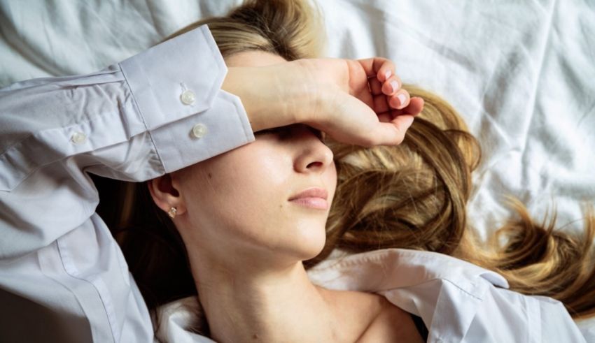 A woman laying in bed with her eyes closed.