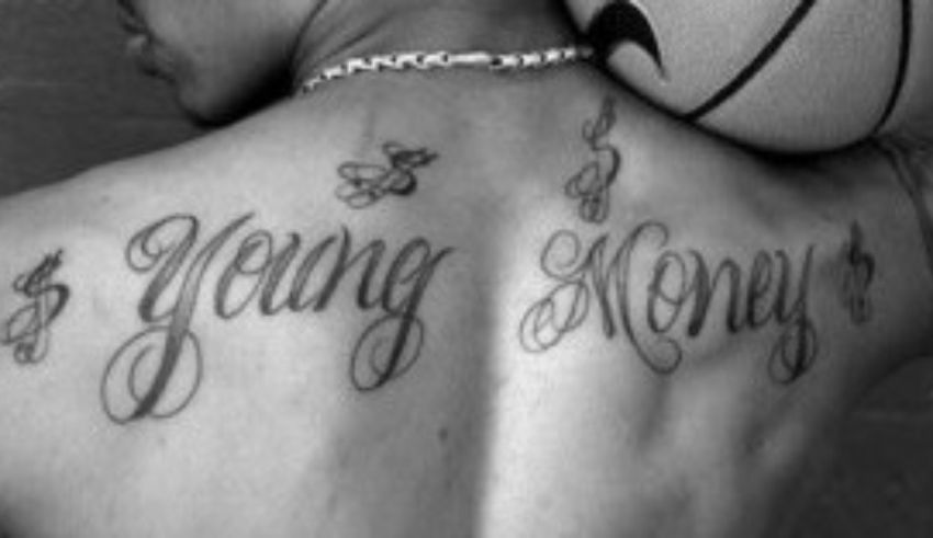 A man with a basketball on his back with the word young money tattooed on it.