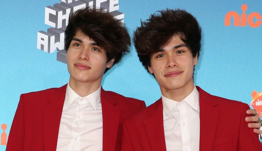 Two boys in red suits posing for a photo.