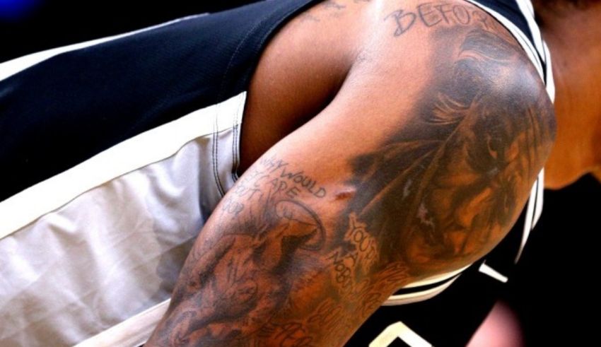 A basketball player with a tattoo on his arm.