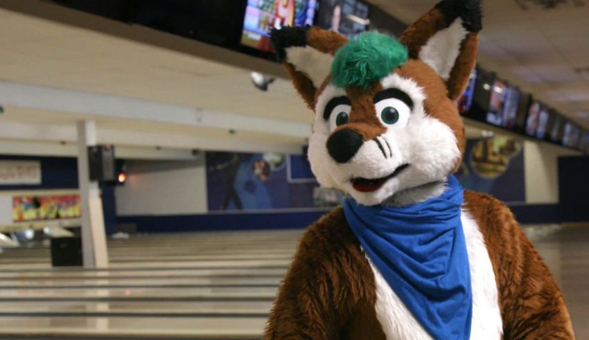 A fox mascot in a bowling alley.