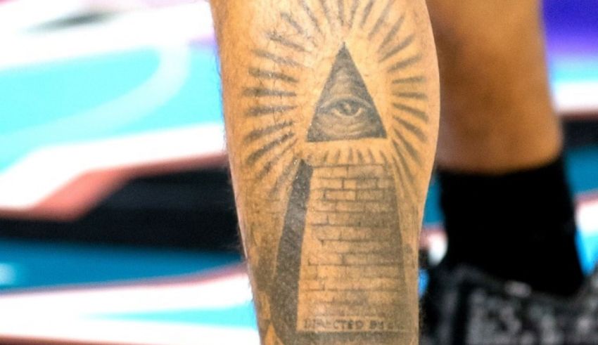 An all seeing eye tattoo on the leg of a basketball player.