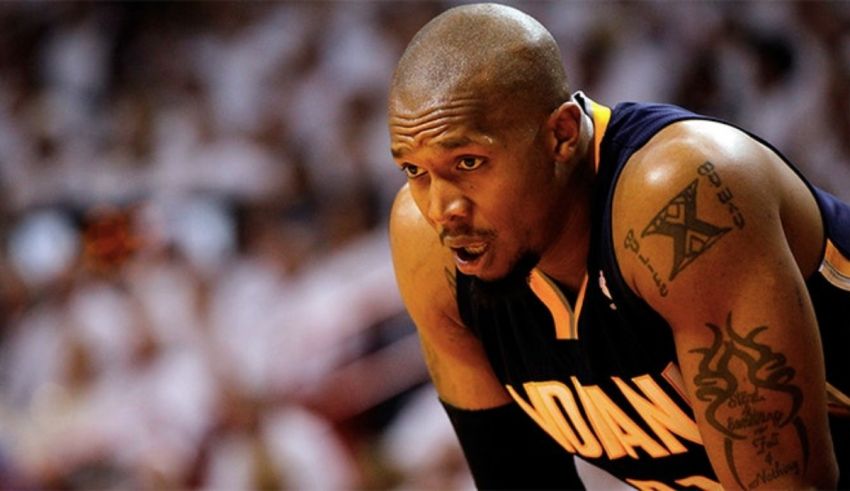 A basketball player with tattoos on his body.