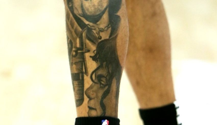 A man's leg with a tattoo on it.