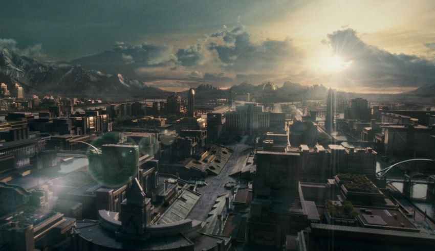 An image of a futuristic city with a sun rising over it.
