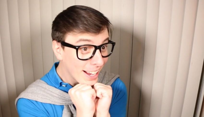 A young man wearing glasses and a scarf.