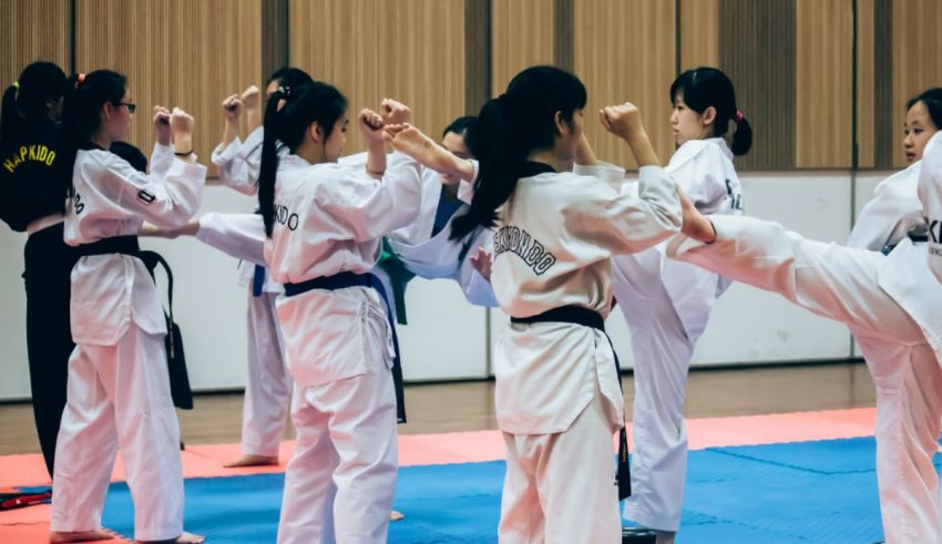 A group of girls practicing karate in a gym.