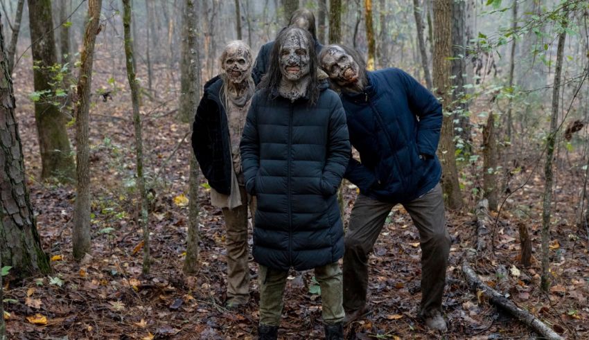 Three zombies standing in a wooded area.