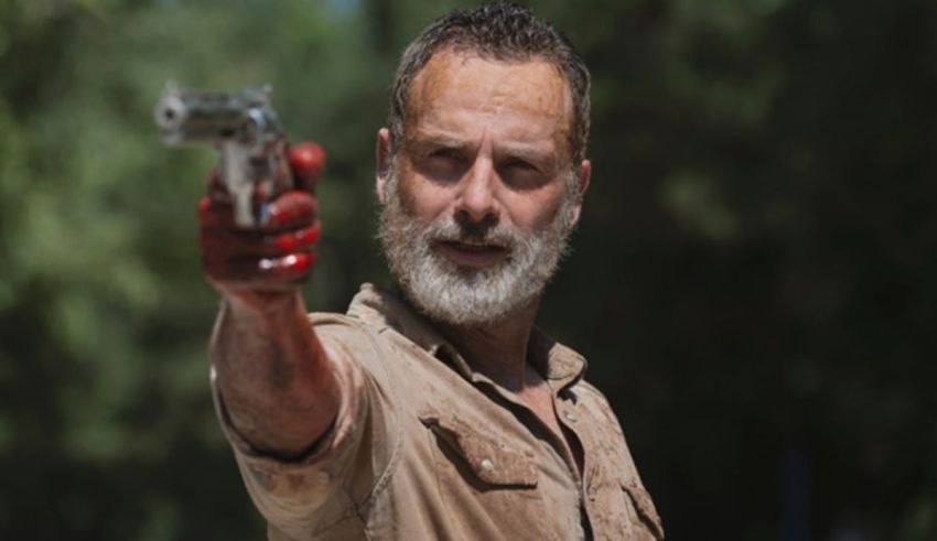 The walking dead's daniel adams holding a gun.