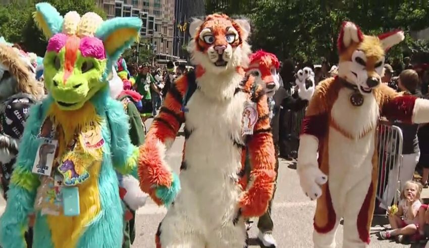 A group of people dressed in animal costumes walking down the street.