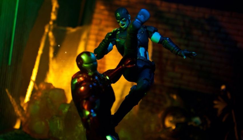 Two action figures are fighting in a dark room.