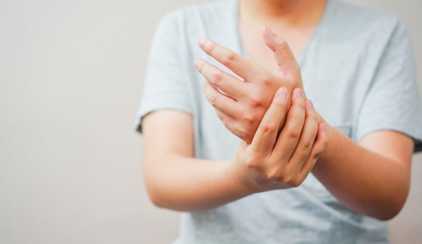 A woman is holding her hands in pain.