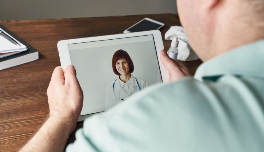 A man is using an ipad to look at a picture of a doctor.