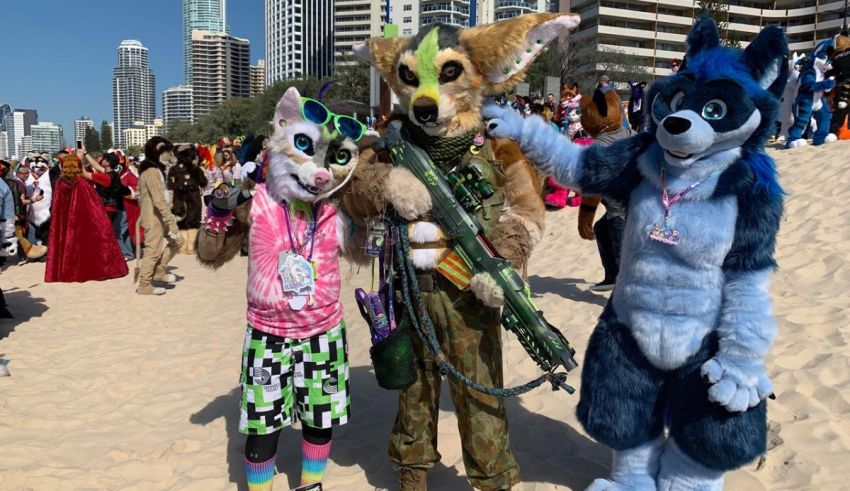 A group of people dressed as animals on the beach.