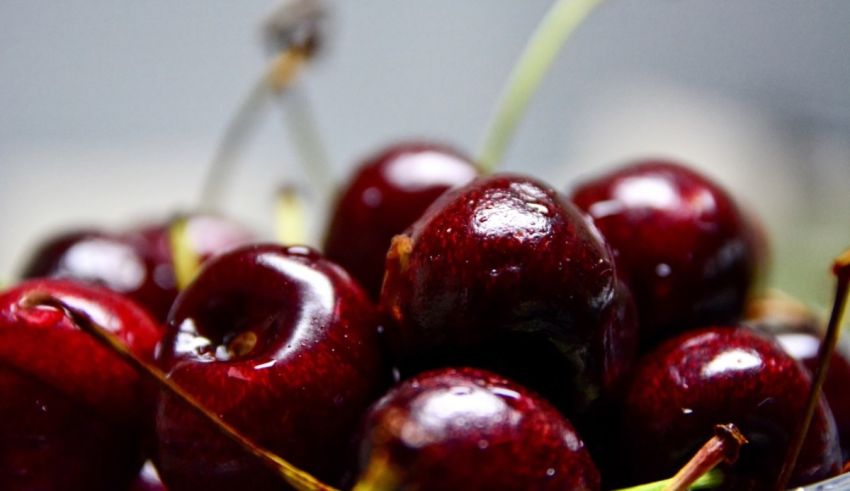 A close up of cherries in a bowl.