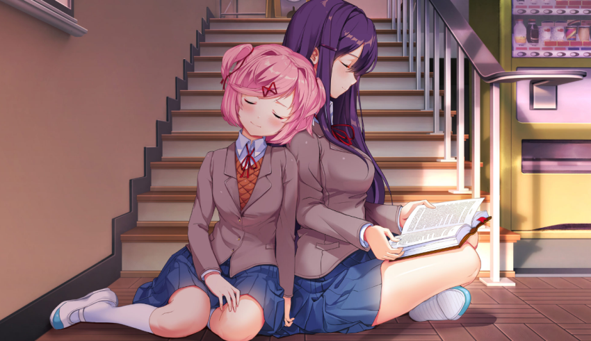 Two girls sitting on the stairs reading a book.