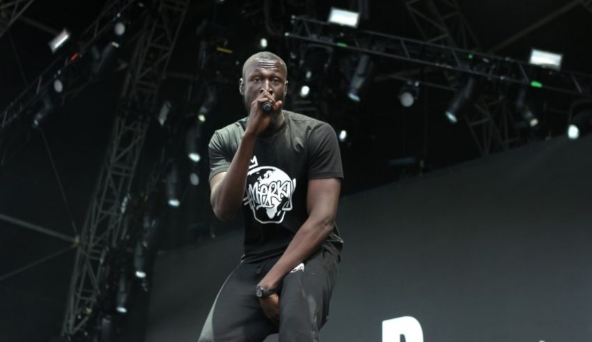 A man in a black shirt is performing on stage.