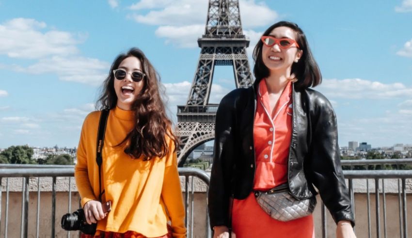 Two women standing in front of the eiffel tower.