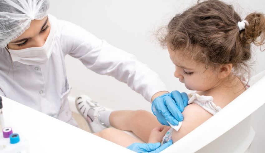 A young girl is getting a vaccine in a doctor's office.