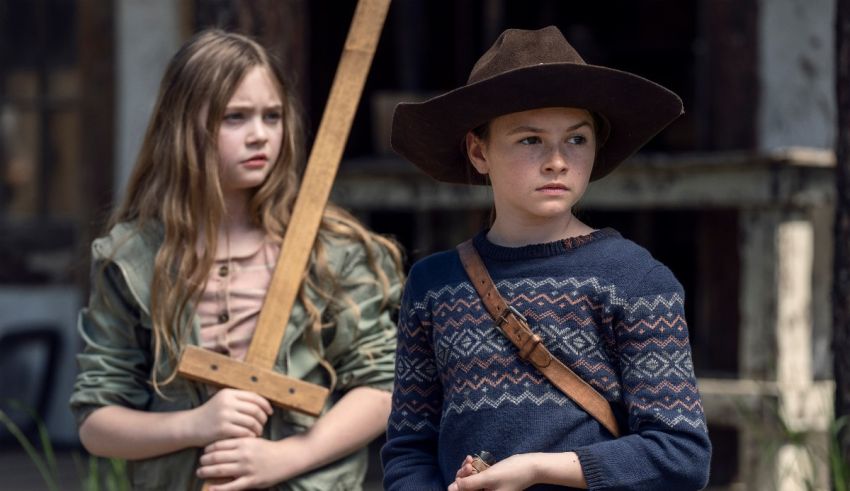 Two girls in cowboy hats standing next to each other.