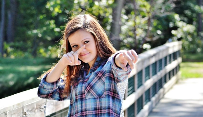 A young girl pointing her finger at the camera.