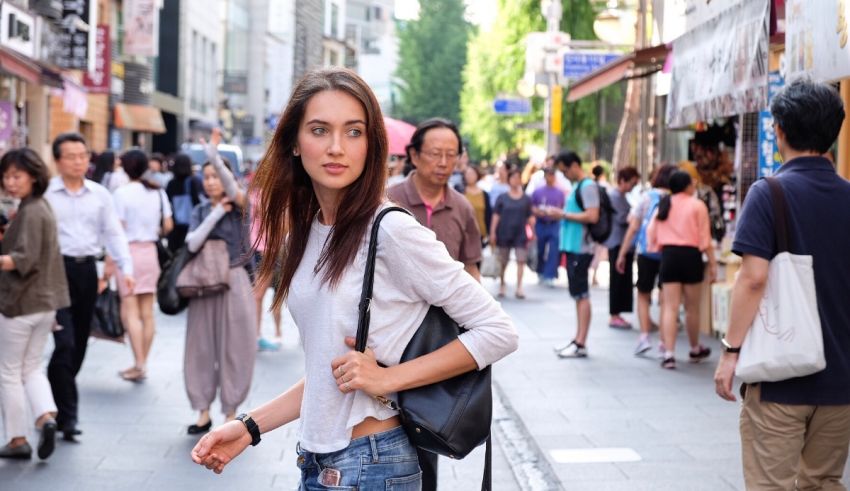 A young woman walking down a busy street.