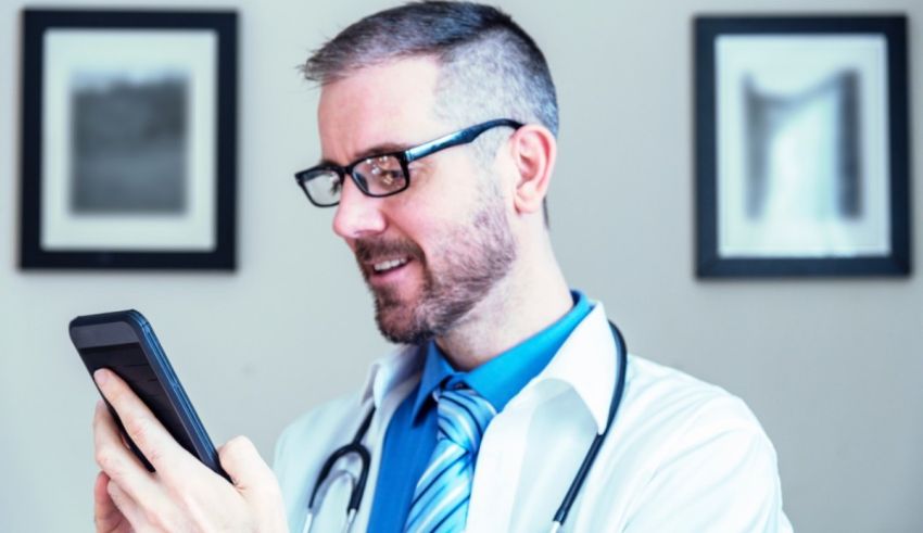 A male doctor using a smart phone.