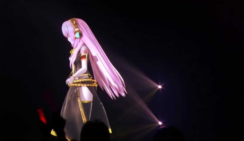 A girl with long pink hair standing on stage.