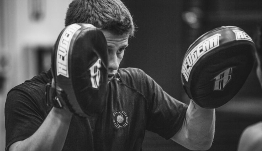 Black and white photo of a man with boxing gloves.