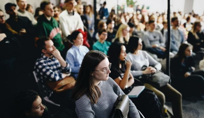 A group of people sitting in an auditorium.