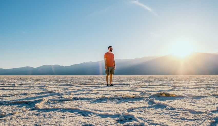 A man standing in the middle of a salt flat.
