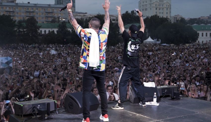 Two men standing on stage in front of a crowd.