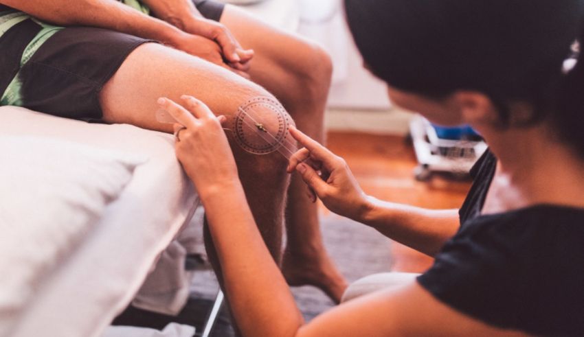 A woman is getting her knee checked by a doctor.