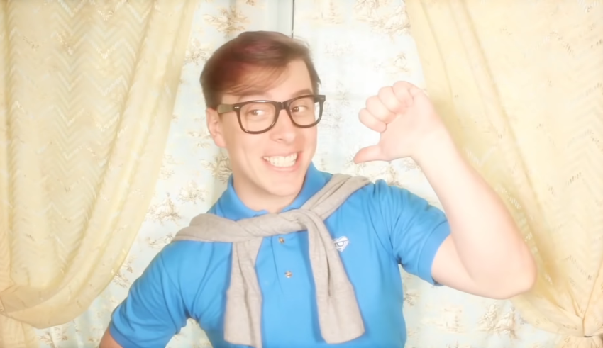 A man wearing glasses and a scarf posing for the camera.