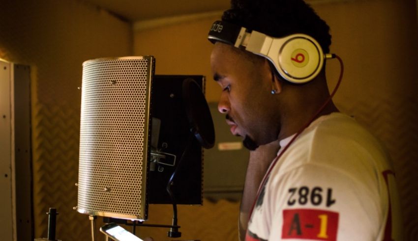 A man wearing headphones in a recording studio.