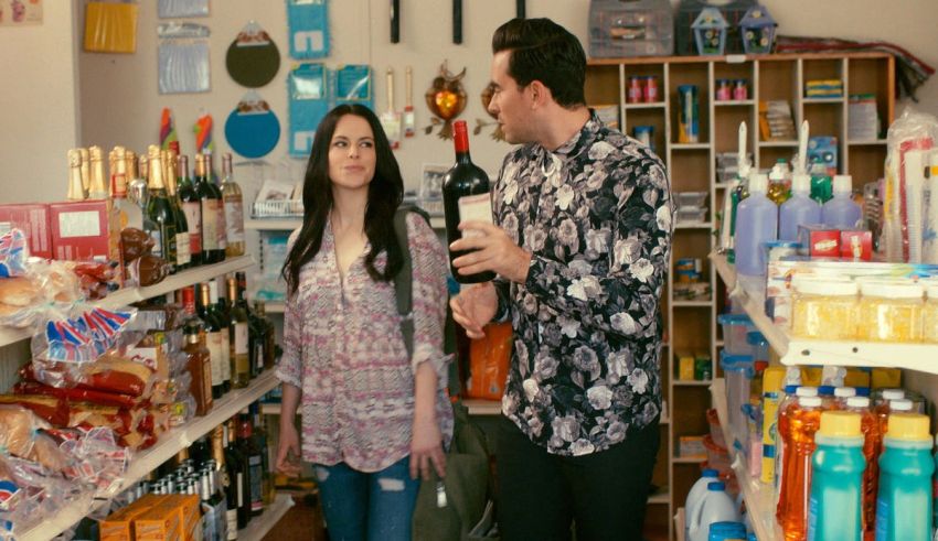 A man and woman standing in a grocery store.