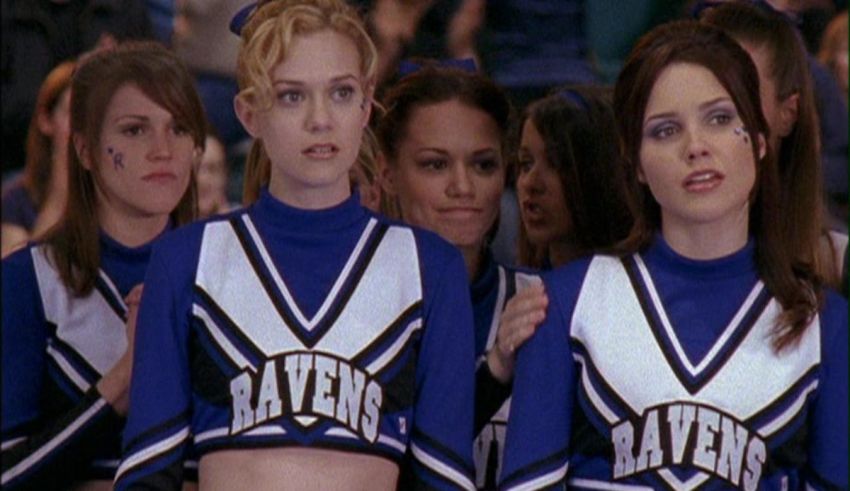 A group of cheerleaders in blue uniforms.