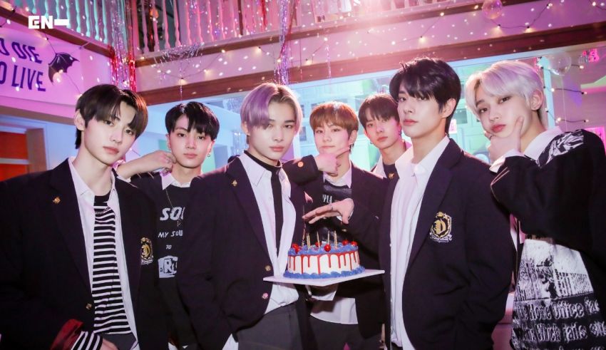 A group of boys posing with a cake in front of them.