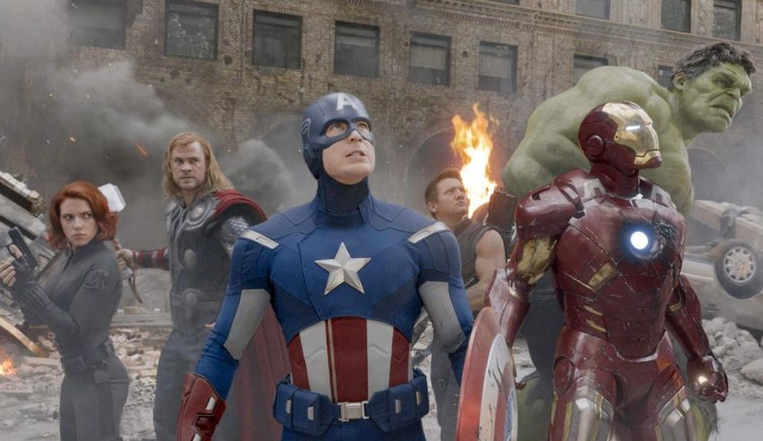 The avengers characters are standing in front of a city.