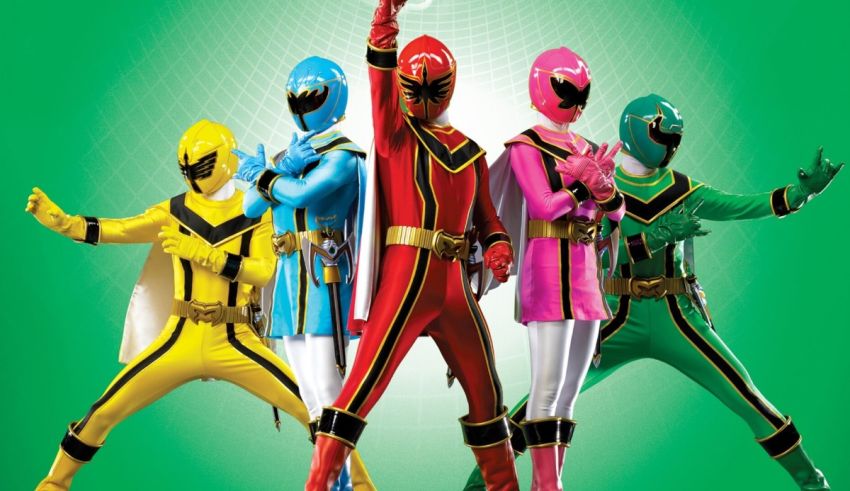 A group of power rangers standing in front of a green background.