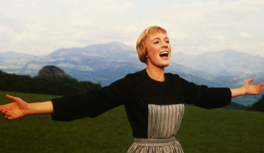 A woman with her arms outstretched in the middle of a field.