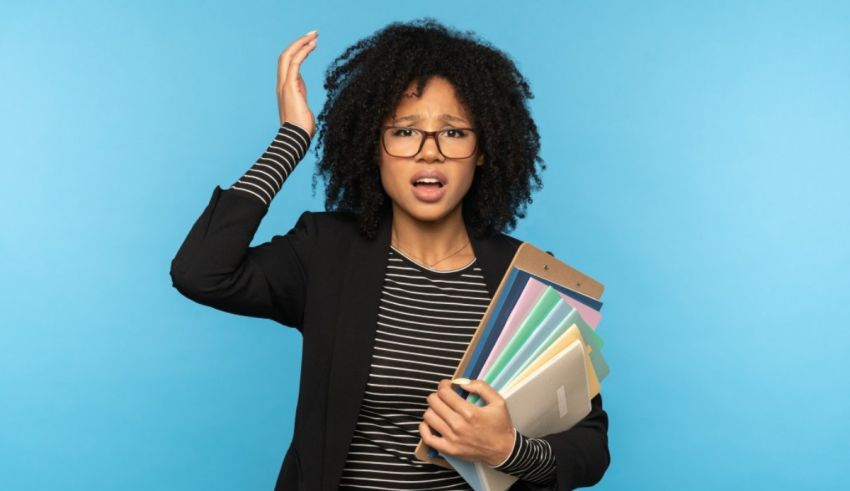 A black woman holding a folder with her hands up on a blue background.