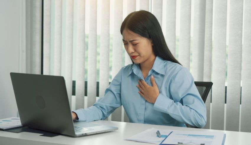Asian businesswoman with chest pain in the office.