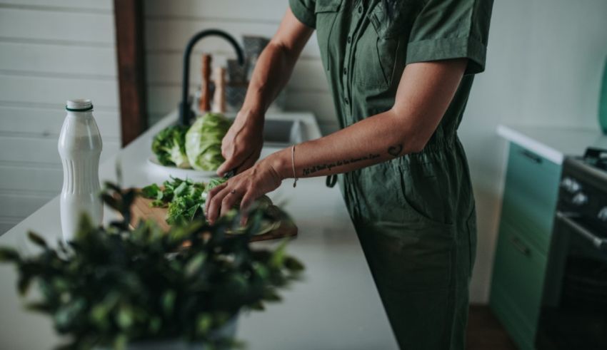 A woman is preparing vegetables in a kitchen.