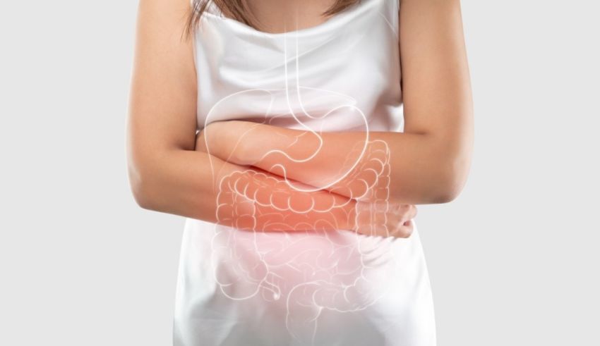 A woman holding her stomach with an image of a stomach.