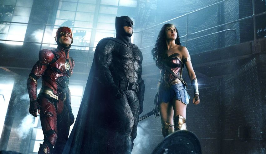 Justice league, wonder woman and flash standing in a dark room.