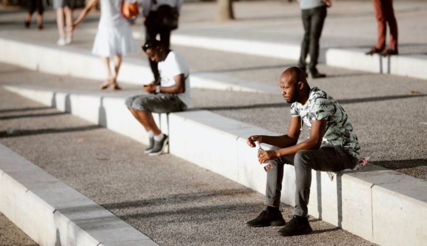 A man sits on a set of concrete steps.