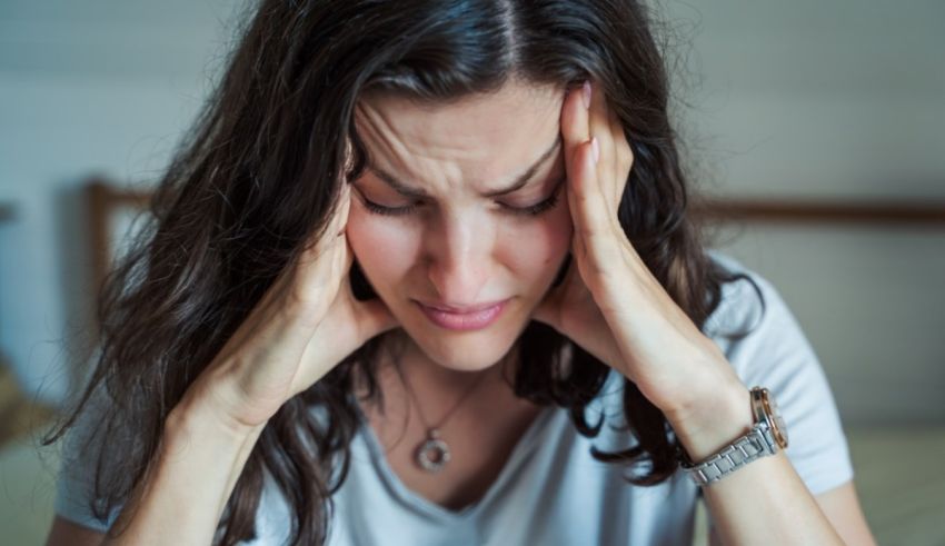 A woman with her hands on her head.