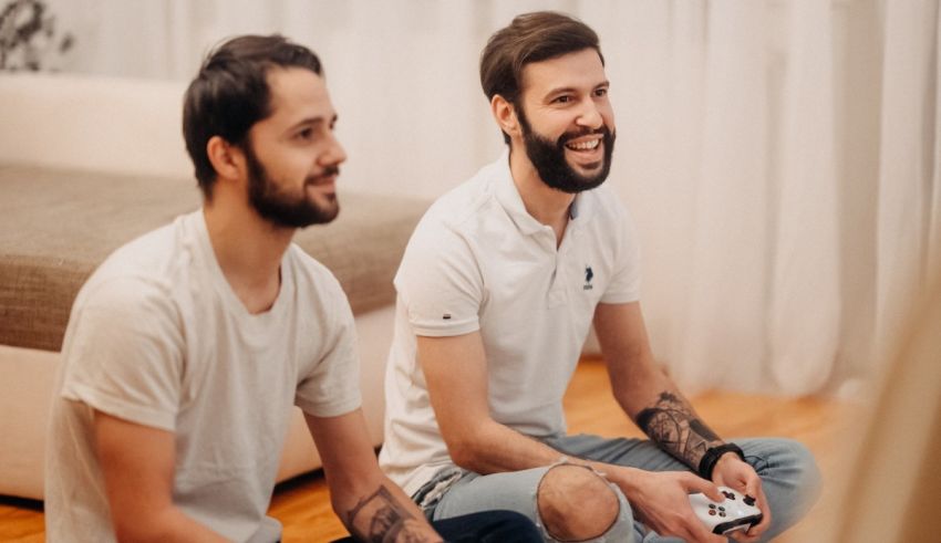 Two men sitting on the floor playing video games.
