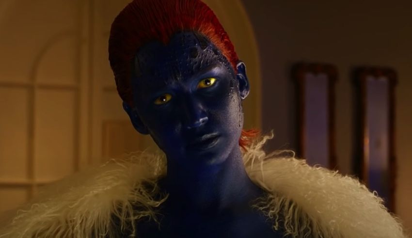 A woman in blue makeup is standing in a room.